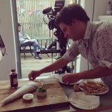 Food assistant Ryan styling the final food shot of the fish and chips.