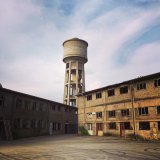 Düdelange watertower behind an abandoned industrial site