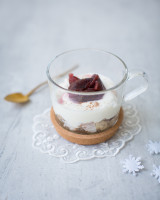 Cup with fruit bread, yoghurt and damson compote and snowflakes decoration